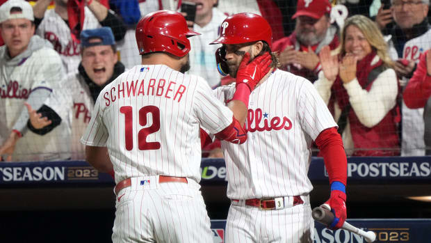Phillies’ Kyle Scharber, Bryce Harper celebrate Schwarber’s home run in NLCS Game 1 win vs. Diamondbacks.