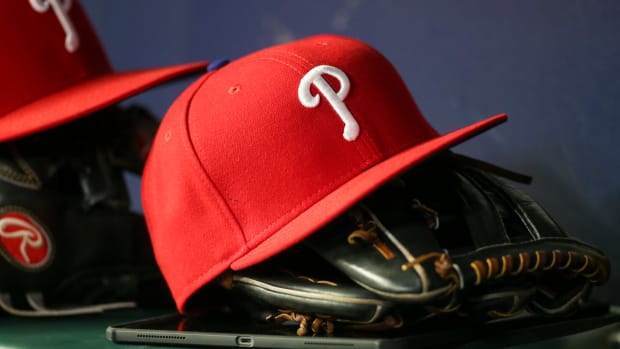 May 25, 2022; Atlanta, Georgia, USA; Detailed view of a Philadelphia Phillies hat and glove in the dugout against the Atlanta Braves in the eighth inning at Truist Park. Mandatory Credit: Brett Davis-USA TODAY Sports