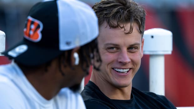 Cincinnati Bengals quarterback Joe Burrow (9) smiles while speaking with Cincinnati Bengals wide receiver Ja'Marr Chase (1) before stretching for the NFL game between the Cincinnati Bengals and Los Angeles Rams at Paycor Stadium in Cincinnati on Monday, Sept. 25, 2023.  