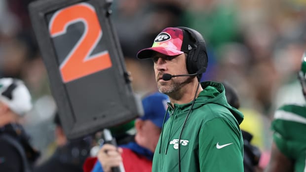 Jets' QB Aaron Rodgers wears a headset during a win over Philadelphia
