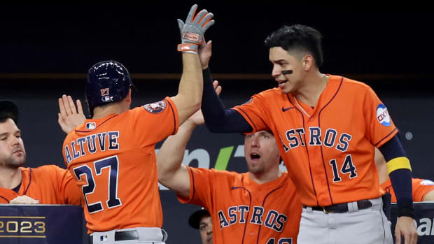 Astros second baseman Jose Altuve (27) celebrates with second baseman Mauricio Dubon (14) after hitting a solo home run during the third inning of Game 3 of the ALCS.