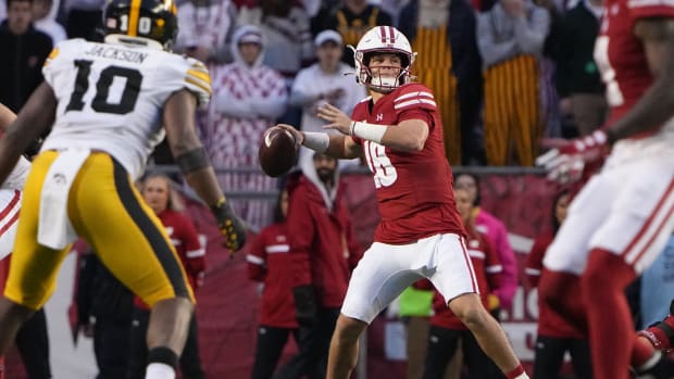 Oct 14, 2023; Madison, Wisconsin, USA; Wisconsin Badgers quarterback Braedyn Locke (18) throws against the Iowa Hawkeyes during the fourth quarter at Camp Randall Stadium. Mandatory Credit: Mark Hoffman-USA TODAY Sports