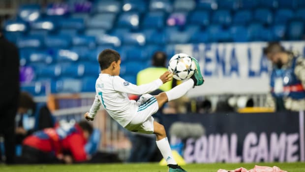 Cristiano Ronaldo Jr pictured performing an overhead kick on the pitch at the Bernabeu Stadium after a UEFA Champions League game between Real Madrid and Bayern Munich in 2018
