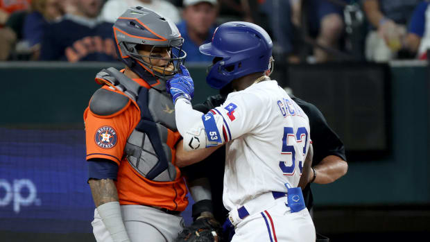Oct 20, 2023; Arlington, Texas, USA; Texas Rangers right fielder Adolis Garcia (53) confronts Houston Astros catcher Martin Maldonado (15) after being hit by a pitch during the eighth inning of game five in the ALCS for the 2023 MLB playoffs at Globe Life Field.