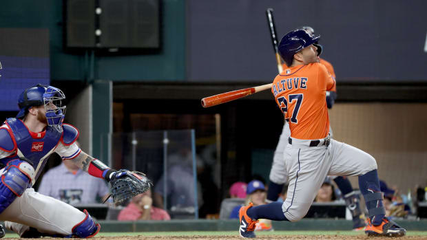 Oct 20, 2023; Arlington, Texas, USA; Houston Astros second baseman Jose Altuve (27) hits a three-run home run during the ninth inning of game five in the ALCS against the Texas Rangers for the 2023 MLB playoffs at Globe Life Field.