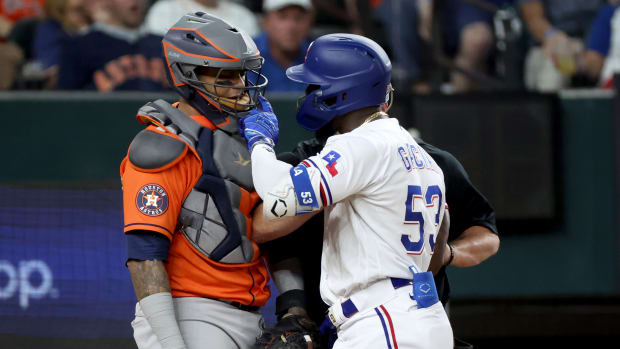 Oct 20, 2023; Arlington, Texas, USA; Texas Rangers right fielder Adolis Garcia (53) confronts Houston Astros catcher Martin Maldonado (15) after being hit by a pitch during the eighth inning of game five in the ALCS for the 2023 MLB playoffs at Globe Life Field. Mandatory Credit: Kevin Jairaj-USA TODAY Sports
