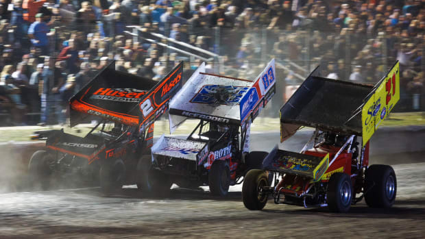 David Gravel (right) passes James McFadden at the finish line to win the final race at Devil's Bowl Speedway. Both cars were lapping the Jimmy Boyd Tribute car, painted as the winning scheme of the inaugural race and raced by Kenny Woodruff. Photo courtesy Trent Gower.