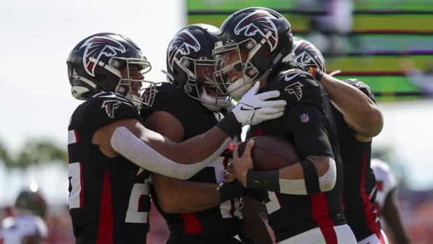 Oct 22, 2023; Tampa, Florida, USA; Atlanta Falcons quarterback Desmond Ridder (9) celebrates with running back Tyler Allgeier (25) after scoring a touchdown against the Tampa Bay Buccaneers in the first quarter at Raymond James Stadium. Mandatory Credit: Nathan Ray Seebeck-USA TODAY Sports  