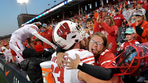 Oct 21, 2023; Champaign, Illinois, USA; Wisconsin Badgers offensive lineman Tanor Bortolini (63) gets a hug from a fan after a game against the Illinois Fighting Illini at Memorial Stadium. Mandatory Credit: Ron Johnson-USA TODAY Sports