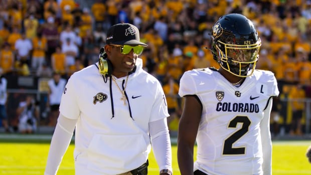 Colorado Buffaloes head coach Deion Sanders with son and quarterback Shedeur Sanders (2) against the Arizona State Sun Devils at Mountain America Stadium