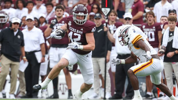 Sep 16, 2023; College Station, Texas, USA; Texas A&M Aggies tight end Max Wright (42) makes a reception as Louisiana Monroe Warhawks linebacker Travor Randle (4) defends during the first quarter at Kyle Field.