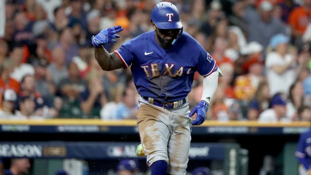 Texas Rangers right fielder Adolis Garcia reacts after hitting a two-RBI single