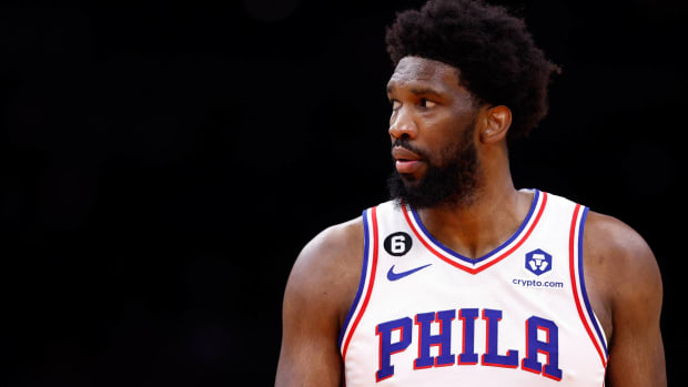 76ers center Joel Embiid looks to his side during a game.