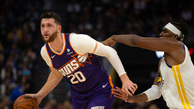 Phoenix Suns center Jusuf Nurkic (20) dribbles past Golden State Warriors forward Kevon Looney (5) during the second quarter at Chase Center.