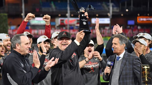 Diamondbacks Managing General Partner Ken Kendrick holds the Warren C. Giles trophy while celebrating the team's first National League pennant since 2001.