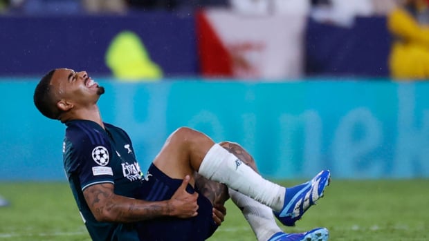 Arsenal striker Gabriel Jesus pictured in pain after suffering an injury in a Champions League game against Sevilla in October 2023