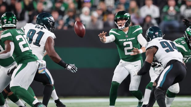 Oct 15, 2023; East Rutherford, New Jersey, USA; New York Jets quarterback Zach Wilson (2) shovel passes the ball to running back Breece Hall (20) in front of Philadelphia Eagles defensive tackle Fletcher Cox (91) during the second half at MetLife Stadium.