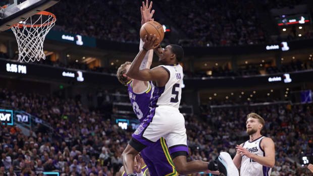 Sacramento Kings guard De'Aaron Fox (5) tries to jump past Utah Jazz forward Lauri Markkanen (23) and to the basket during the second quarter at Delta Center.