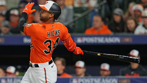 Oct 8, 2023; Baltimore, Maryland, USA; Baltimore Orioles center fielder Aaron Hicks (34) hits a three run home run during the ninth inning against the Texas Rangers during game two of the ALDS for the 2023 MLB playoffs at Oriole Park at Camden Yards. Mandatory Credit: Mitch Stringer-USA TODAY Sports