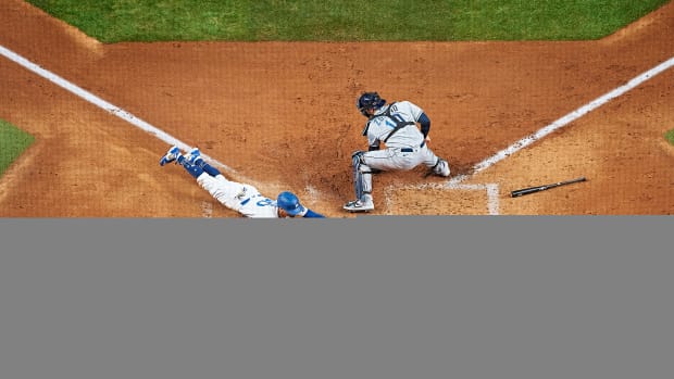 Dodgers’ Mookie Betts slides headfirst into home plate ahead of a tag from Rays catcher Mike Zunino during the 2020 World Series