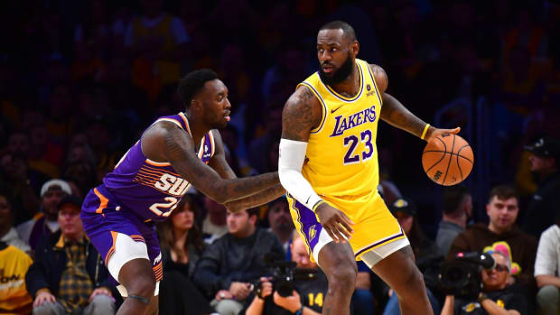 Los Angeles Lakers forward LeBron James (23) moves the ball against Phoenix Suns forward Nassir Little (25) during the first half at Crypto.com Arena.