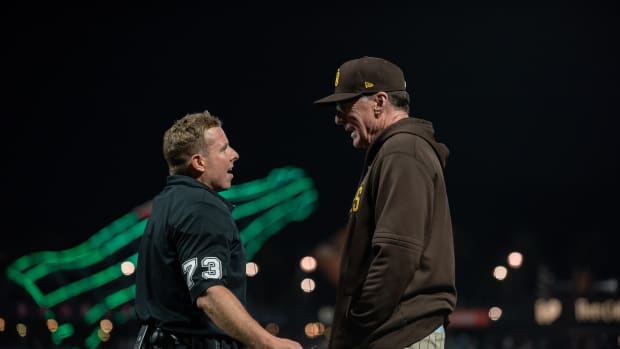 Bob Melvin explains to umpire Tripp Gibson that the slide in left field is locked because of him.