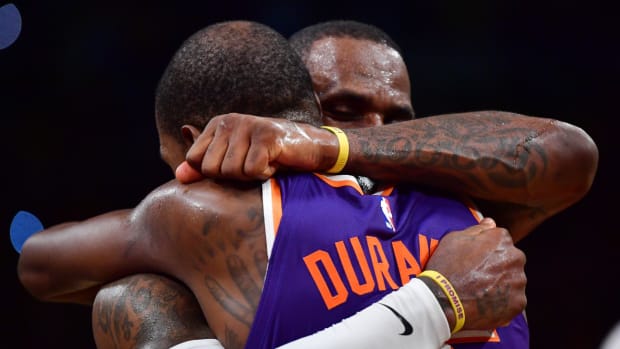Phoenix Suns forward Kevin Durant (35) meets with Los Angeles Lakers forward LeBron James (23) following the game at Crypto.com Arena.