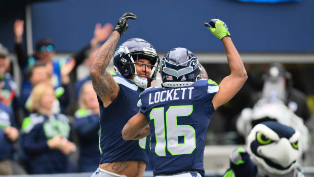 Oct 22, 2023; Seattle, Washington, USA; Seattle Seahawks wide receiver Jaxon Smith-Njigba (11) and Seattle Seahawks wide receiver Tyler Lockett (16) celebrate after Jaxon Smith-Njigba scored a touchdown against the Arizona Cardinals during the first half at Lumen Field. Mandatory Credit: Steven Bisig-USA TODAY Sports