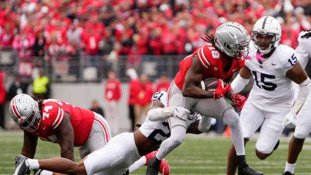 Oct 21, 2023; Columbus, Ohio, USA; Ohio State Buckeyes wide receiver Marvin Harrison Jr. (18) drags Penn State Nittany Lions safety Kevin Winston Jr. (21) during the second half of the NCAA football game at Ohio Stadium. Ohio State won 20-12.