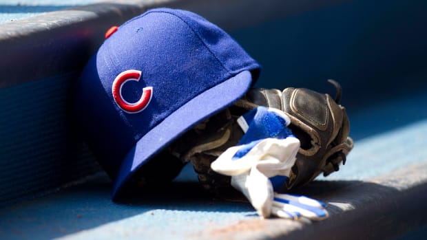 Apr 10, 2011; Milwaukee, WI, USA; Chicago Cubs hat and glove in the dugout prior to the game against the Milwaukee Brewers at Miller Park. The Brewers defeated the Cubs 6-5. Mandatory Credit: Jeff Hanisch-USA TODAY Sports