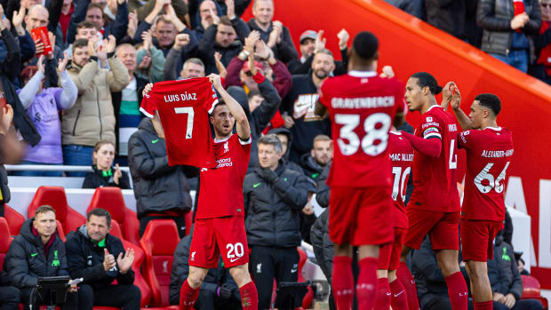 Diogo Jota pictured holding up a Liverpool jersey printed with the name of Luis Diaz during a Premier League game against Nottingham Forest in October 2023. Diaz had missed the game after his parents were kidnapped in Colombia.