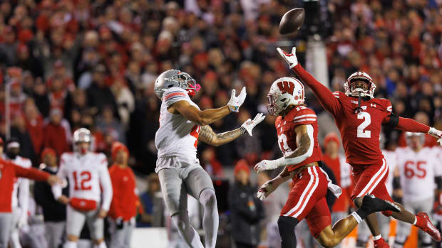 Oct 28, 2023; Madison, Wisconsin, USA; Wisconsin Badgers cornerback Ricardo Hallman (2) defends the pass intended for Ohio State Buckeyes wide receiver Julian Fleming (4) during the first quarter at Camp Randall Stadium. Mandatory Credit: Jeff Hanisch-USA TODAY Sports