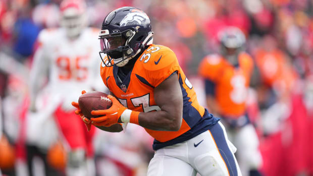 Denver Broncos running back Javonte Williams (33) carries the ball for a touchdown against the Kansas City Chiefs in the first quarter at Empower Field at Mile High.