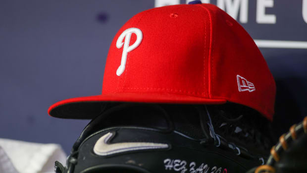 May 26, 2023; Atlanta, Georgia, USA; A detailed view of a Philadelphia Phillies hat and glove on the bench against the Atlanta Braves in the seventh inning at Truist Park. Mandatory Credit: Brett Davis-USA TODAY Sports