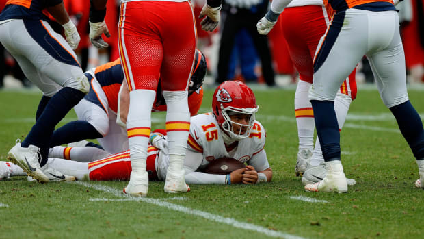 Oct 29, 2023; Denver, Colorado, USA; Kansas City Chiefs quarterback Patrick Mahomes (15) lies on the ground after being sacked in the third quarter against the Denver Broncos at Empower Field at Mile High. Mandatory Credit: Isaiah J. Downing-USA TODAY Sports  