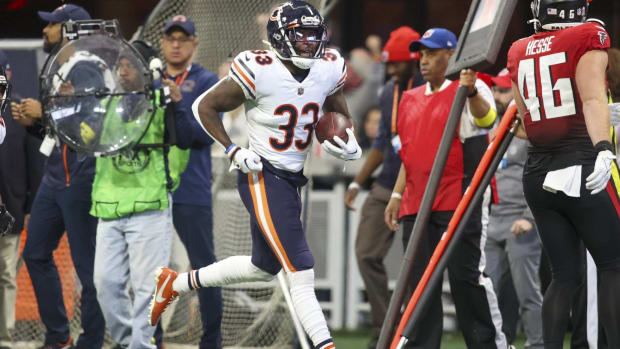 Bears cornerback Jaylon Johnson carries a ball after recovering a football in a game vs. the Falcons.
