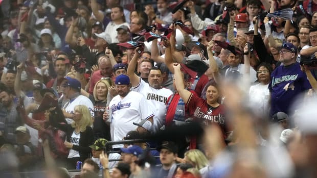 Fans cheer from the stands as the Arizona Diamondbacks play Game 3 of the World Series against the Texas Rangers at Chase Field in Phoenix, Ariz., on Oct. 30, 2023.