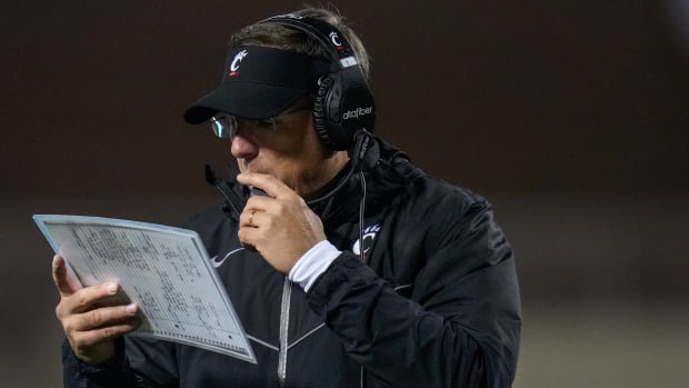 Cincinnati Bearcats head coach Scott Satterfield attempts to call a play following a touchdown in the fourth quarter of the NCAA Big12 football game between the Oklahoma State Cowboys and the Cincinnati Bearcats at Boone Pickens Stadium in Stillwater, Okla., on Saturday, Oct. 28, 2023