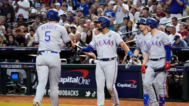 Texas Rangers shortstop Corey Seager (5) is congratulated by second baseman Marcus Semien (2) after hitting a two-run home run against the Arizona Diamondbacks during the second inning in Game 4 of the 2023 World Series at Chase Field in Phoenix, AZ. The DBacks lost to the Rangers 11-7, putting the Ranger at 3-1 in the World Series.