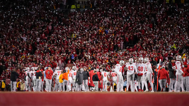 Oct 28, 2023; Madison, Wisconsin, USA; Wisconsin Badgers fans hold their cell phones with flashlights on as the Ohio State Buckeyes huddle during the second half of the NCAA football game at Camp Randall Stadium. Ohio State won 24-10.