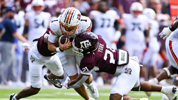 Sep 23, 2023; College Station, Texas, USA; Auburn Tigers quarterback Payton Thorne (1) is tackled by Texas A&M Aggies defensive back Bryce Anderson (1) and linebacker Taurean York (21) during the first quarter at Kyle Field.