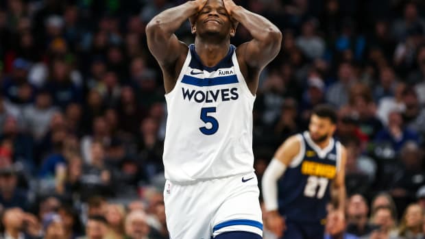 Nov 1, 2023; Minneapolis, Minnesota, USA; Minnesota Timberwolves guard Anthony Edwards (5) reacts to a shot against the Denver Nuggets during the first half at Target Center.