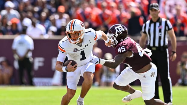 Sep 23, 2023; College Station, Texas, USA; Auburn Tigers quarterback Payton Thorne (1) runs the ball on a quarterback keeper as Texas A&M Aggies linebacker Edgerrin Cooper (45) attempts a tackle during the second quarter at Kyle Field.