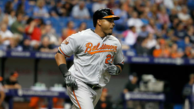 May 6, 2014; St. Petersburg, FL, USA; Baltimore Orioles designated hitter Nelson Cruz (23) singles during the seventh inning against the Tampa Bay Rays at Tropicana Field. Mandatory Credit: Kim Klement-USA TODAY Sports