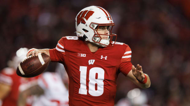Oct 28, 2023; Madison, Wisconsin, USA; Wisconsin Badgers quarterback Braedyn Locke (18) throws a pass during the fourth quarter against the Ohio State Buckeyes at Camp Randall Stadium. Mandatory Credit: Jeff Hanisch-USA TODAY Sports