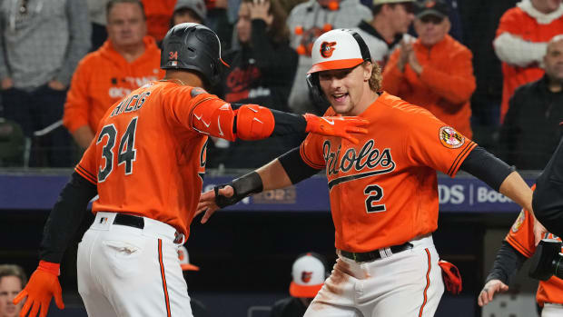 Oct 8, 2023; Baltimore, Maryland, USA; Baltimore Orioles center fielder Aaron Hicks (34) celebrates with third baseman Gunnar Henderson (2) celebrates after hitting a three run home run during the ninth inning against the Texas Rangers during game two of the ALDS for the 2023 MLB playoffs at Oriole Park at Camden Yards. Mandatory Credit: Mitch Stringer-USA TODAY Sports