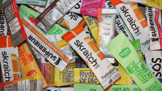 A pile of electrolyte powder packets, including Skratch Labs, Bubs, LMNT and more