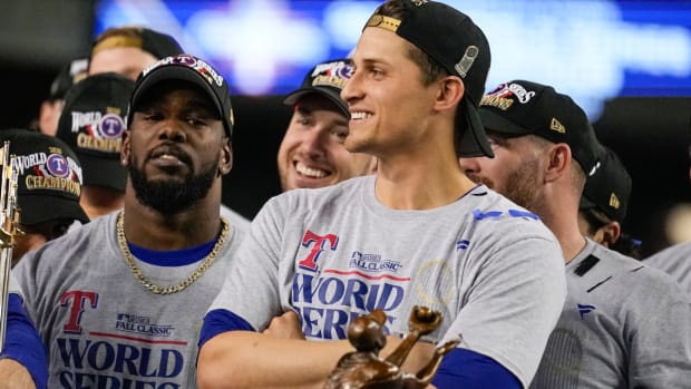 Texas Rangers shortstop Corey Seager stand by the trophy after Game 5 of the baseball World Series against the Arizona Diamondbacks Wednesday, Nov. 1, 2023, in Phoenix. The Rangers won 5-0 to win the series 4-1. (AP Photo/Brynn Anderson)