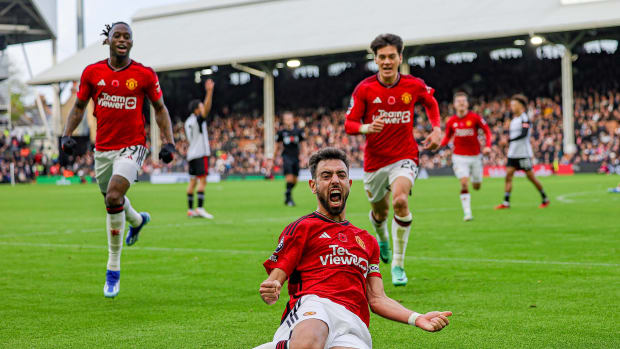 Bruno Fernandes pictured sliding on his knees after scoring the winning goal for Manchester United away at Fulham in November 2023
