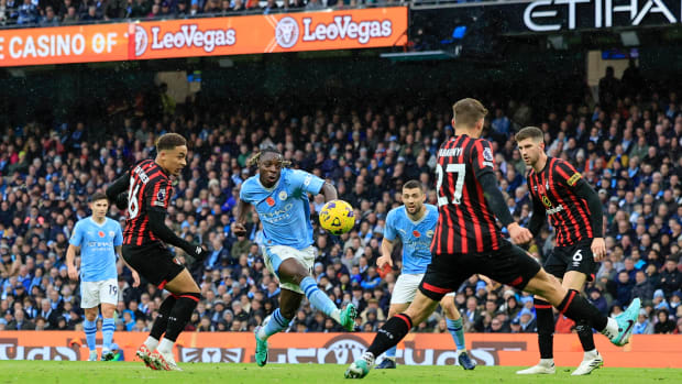 Jeremy Doku pictured (center) shooting to score for Manchester City against Bournemouth in November 2023